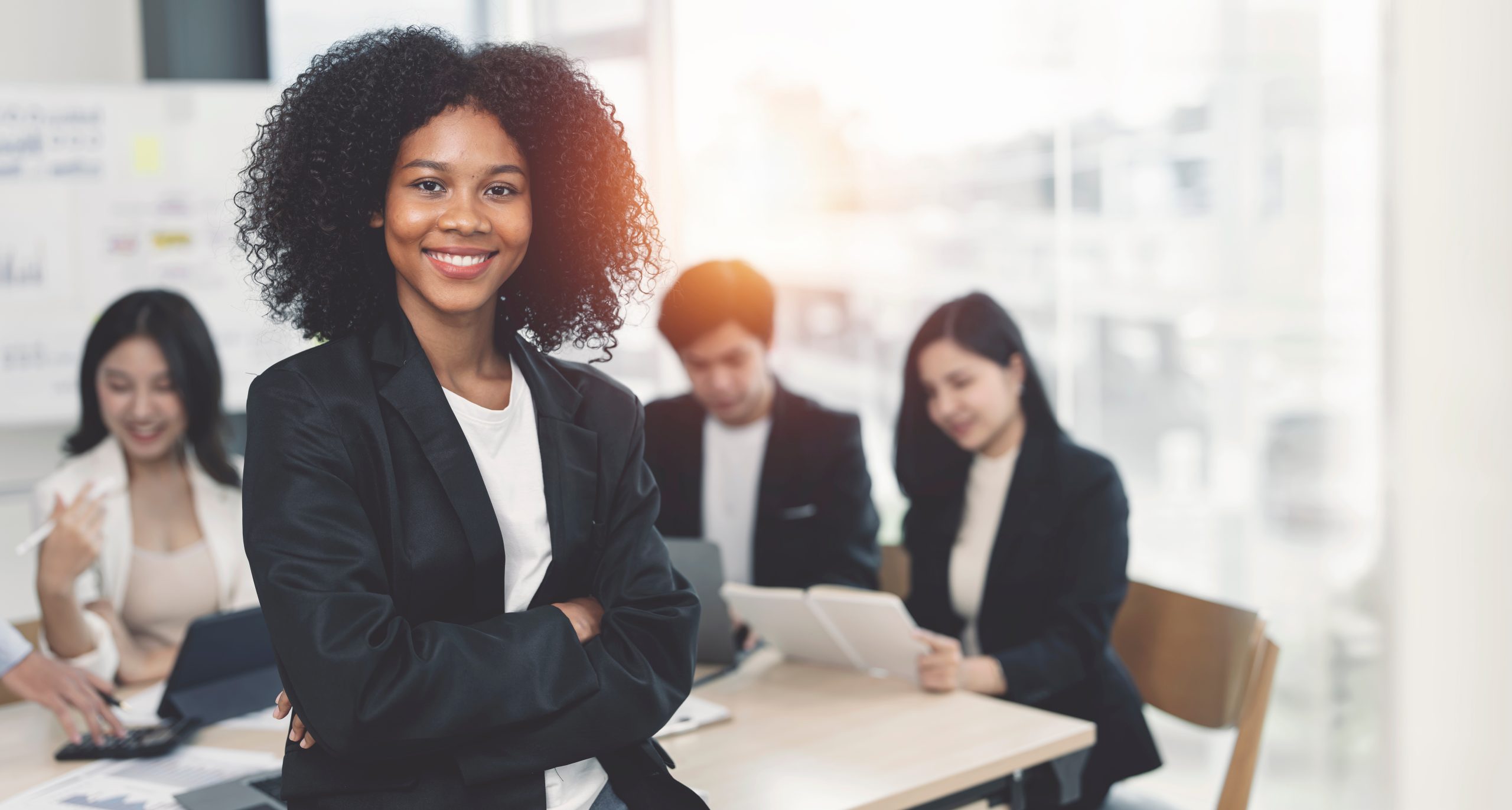 Portrait of smiley african american businesswoman standing in meeting room.